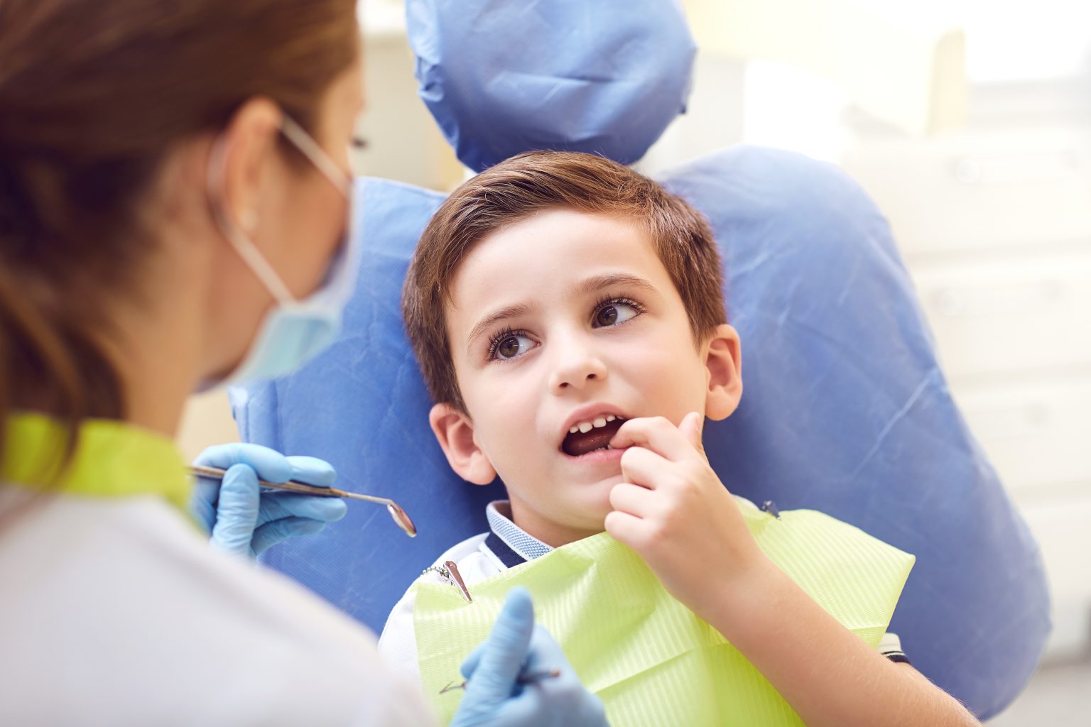A Child With A Dentist In A Dental Office.