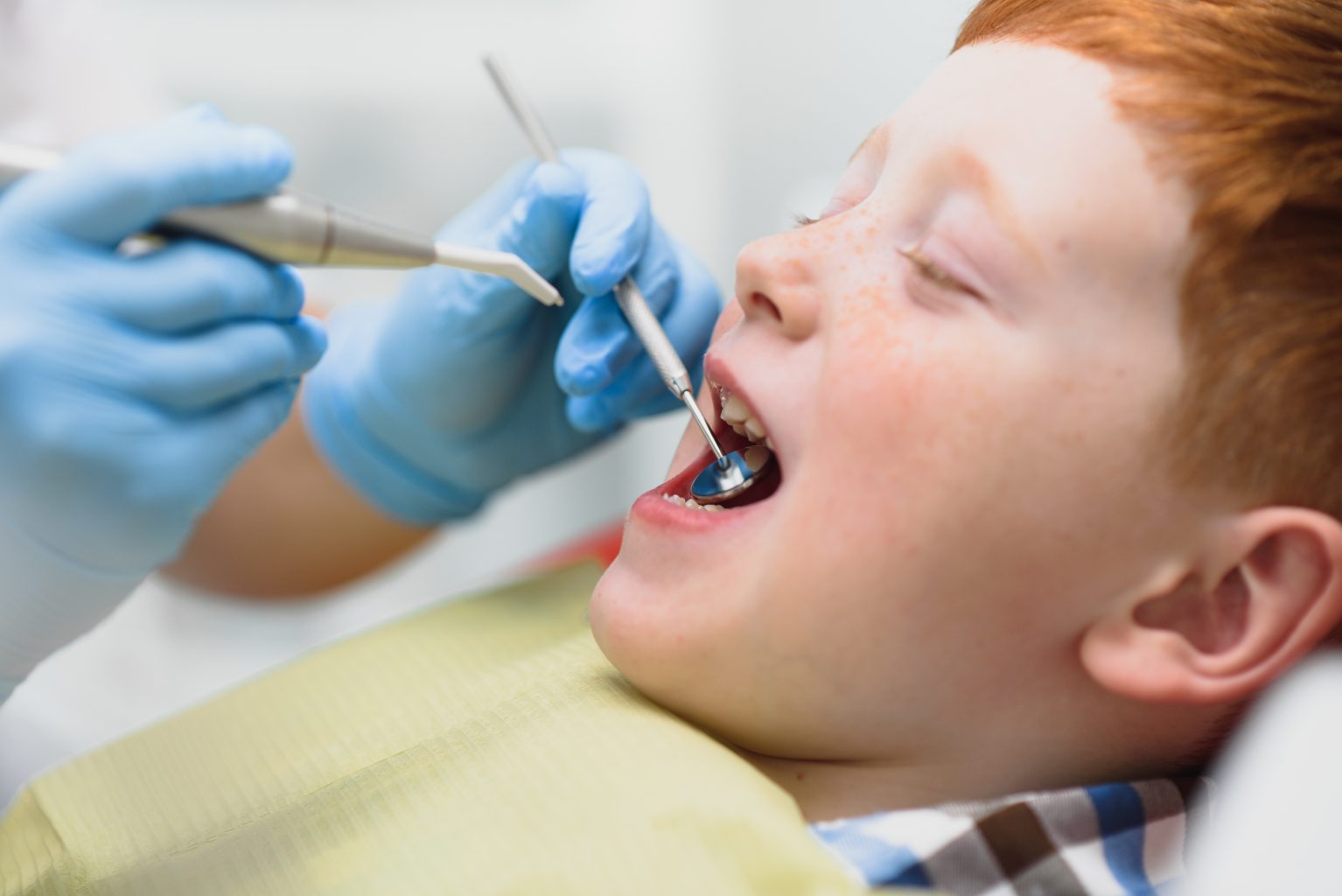 Boy Satisfied With The Service In The Dental Office. Concept Of Pediatric Dental Treatment
